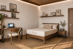 Modern bedroom with wooden bed featuring an organic mattress by Lifekind, desk, and shelves.